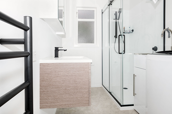 While modern upgrades create a fresh look, removing the old shower-over-bath made all the difference in this bathroom renovation, creating space.