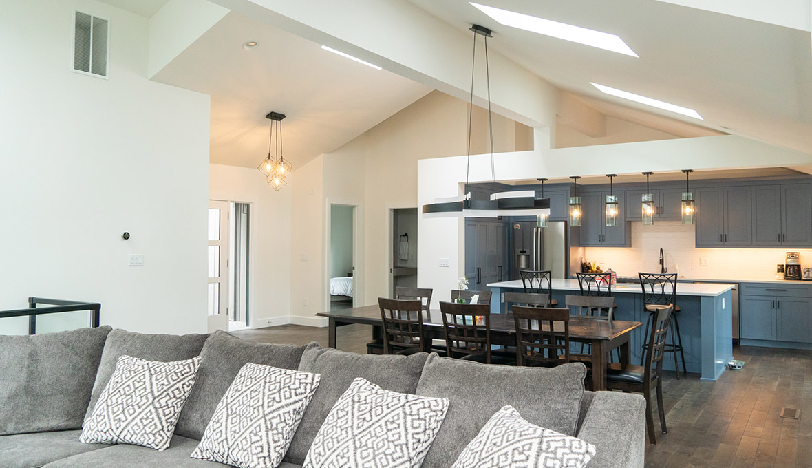 Spacious remodeled living room as part of full home renovations in Lake Oswego, featuring modern furnishings, hardwood floors, and a cozy fireplace.