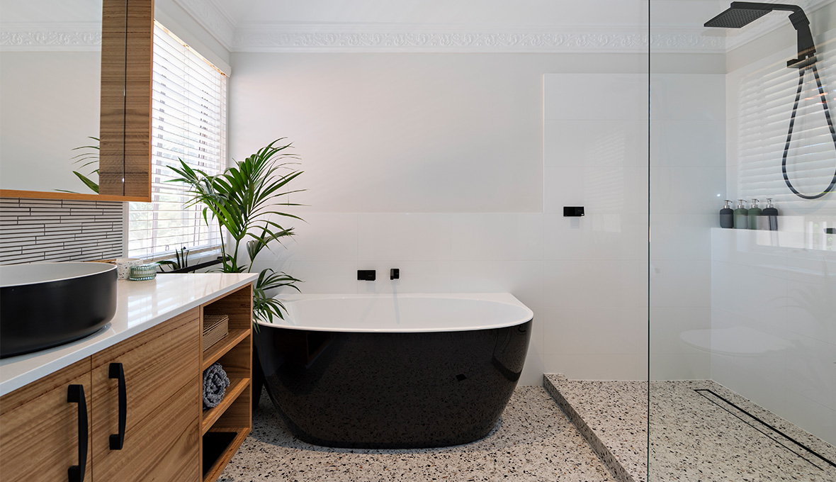 Black freestanding bathtub and walk in shower with black fixtures in Broomfield.