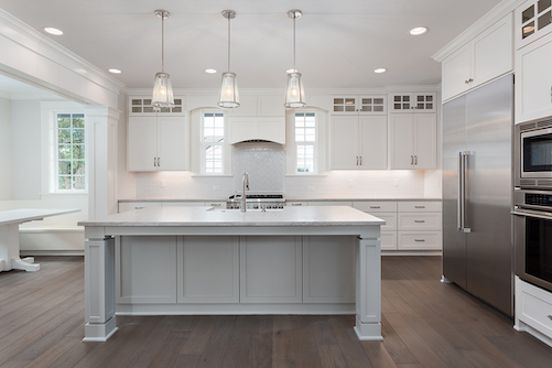 Open-plan kitchen with hanging pendant lights