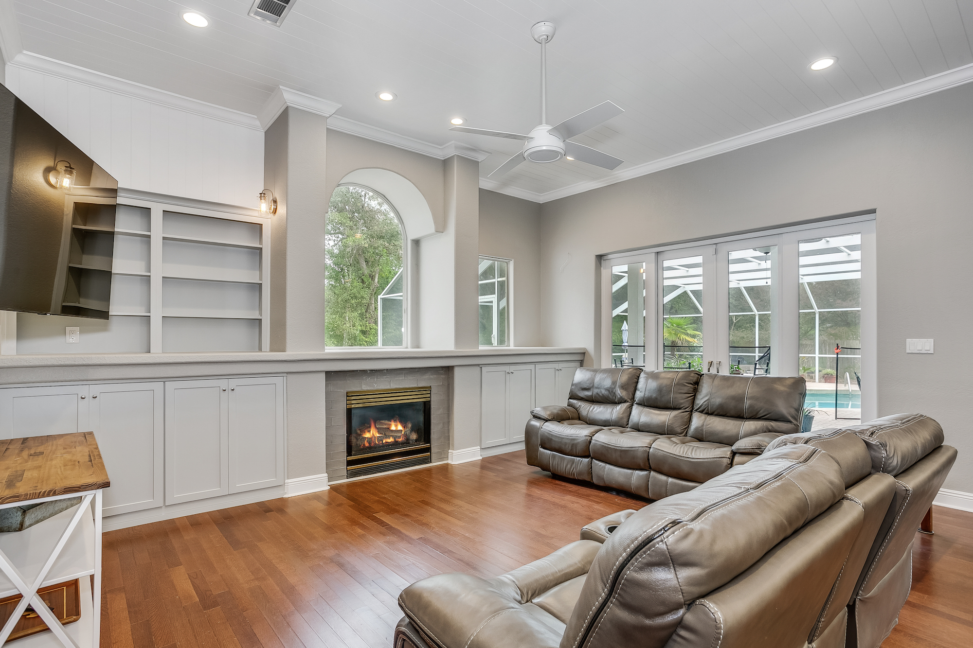 lounge  addition with a fireplace and built-in shelves